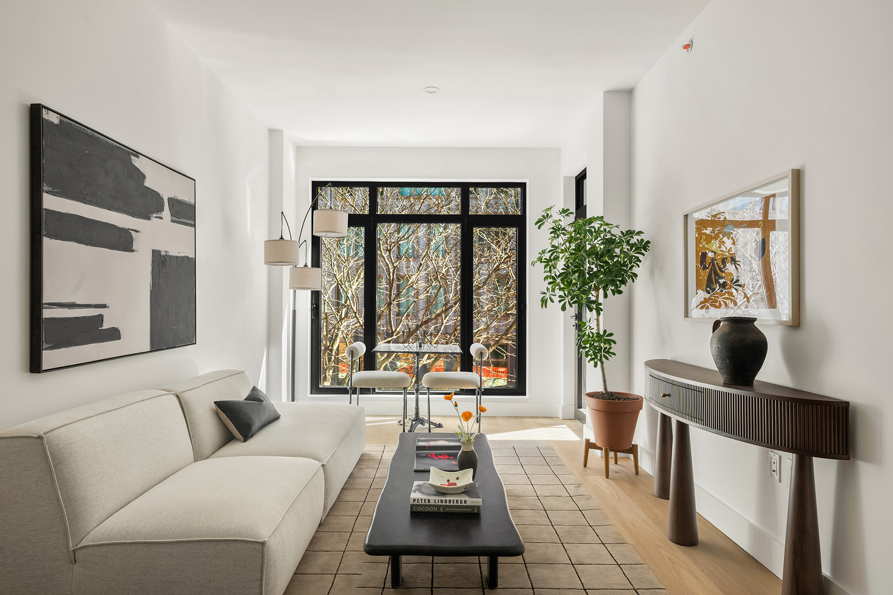 Living room with oak flooring and oversized windows